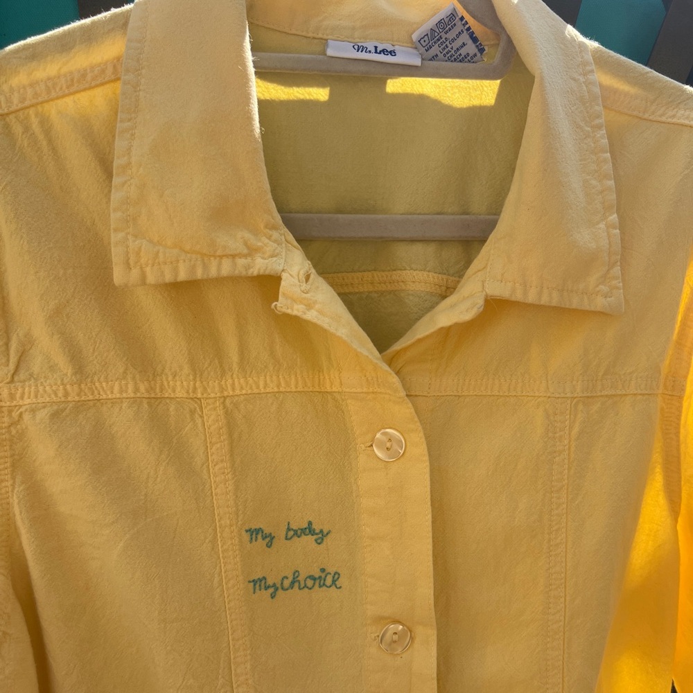Yellow cotton buttonup jacket with hand embroidered “My Body, My Choice” details